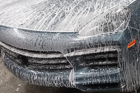 Porsche Cayenne covered in snow foam during the wash