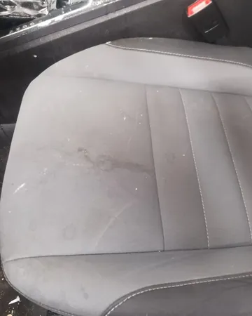 Driver's seat cushion with dark stains