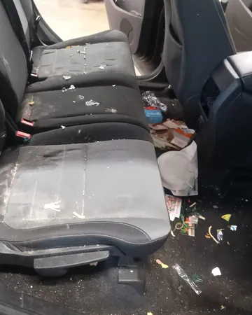 Rear seat and floor littered with cups and wrappers